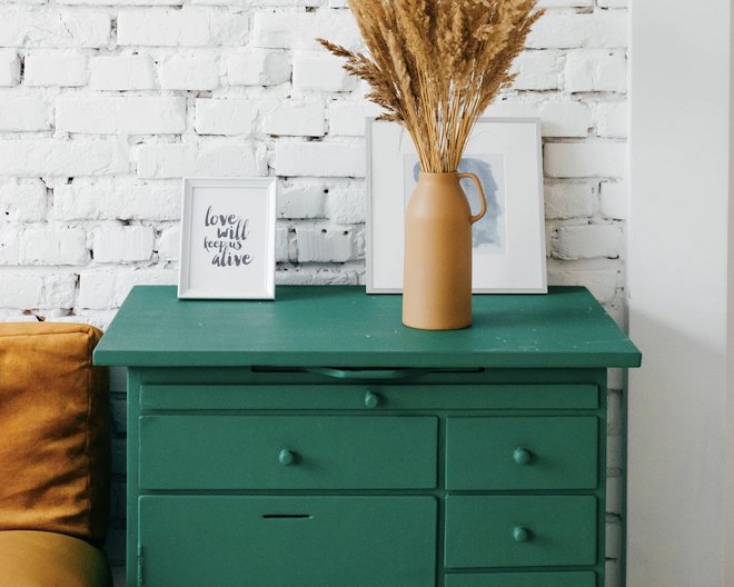 green wardrobe with vase and pictures